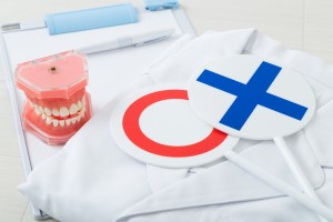 丸バツの札と歯の模型とバインダーと模型